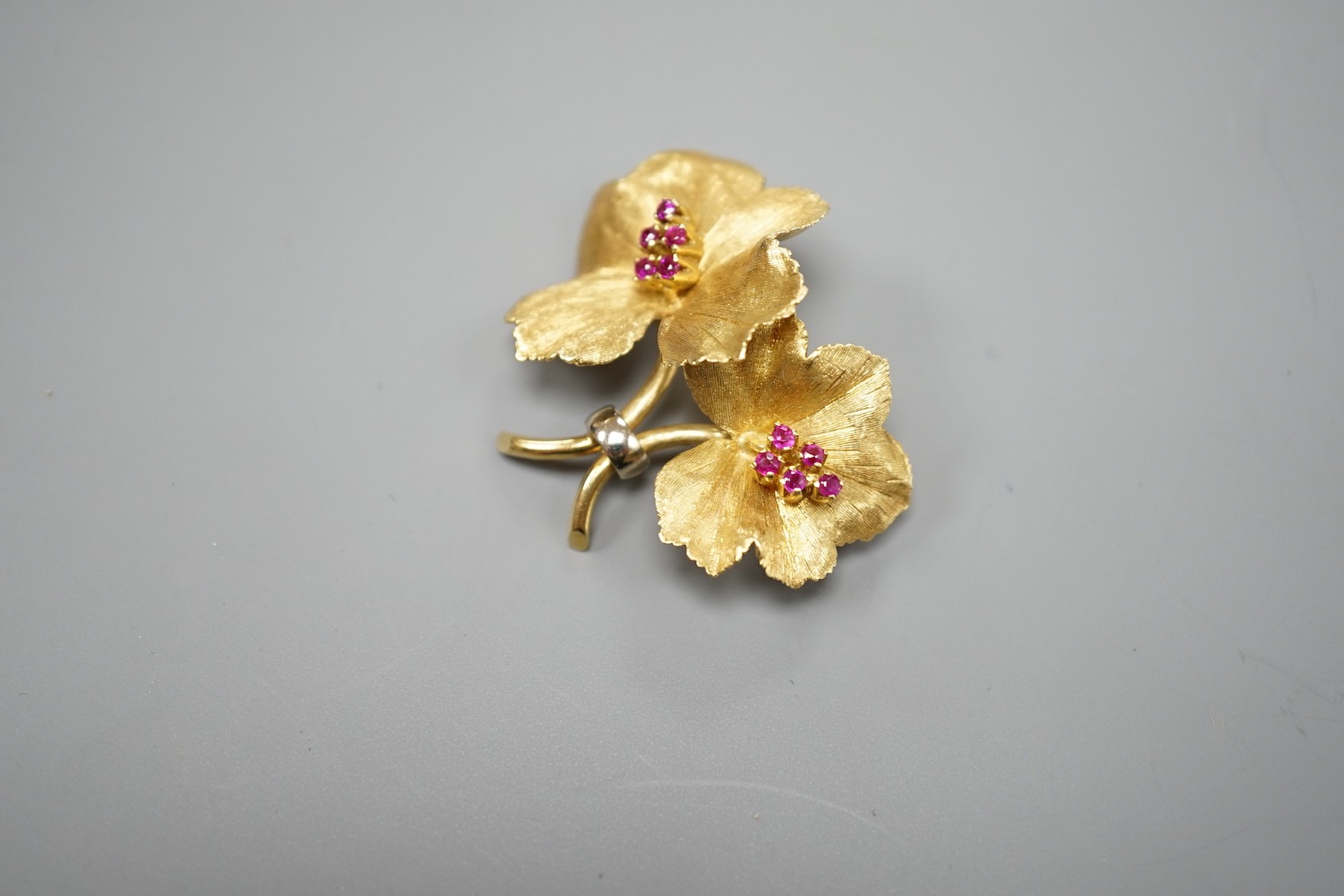 A gold and ruby cluster set double flower head brooch